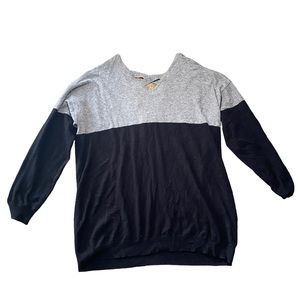 Hrey and black sweater with back opening